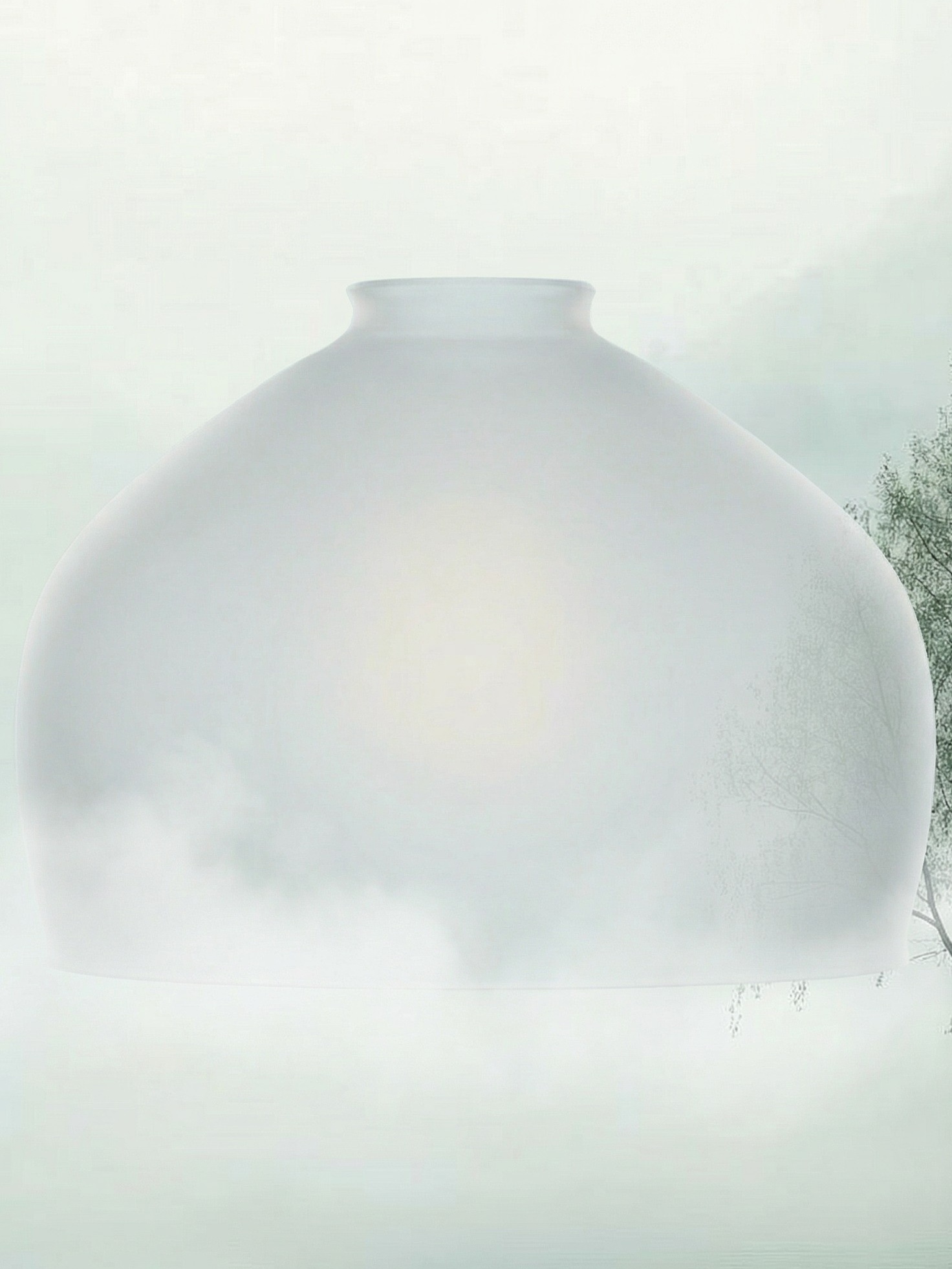 A veil of winter mist, soft and diffused, where light drifts gently through a tranquil landscape.