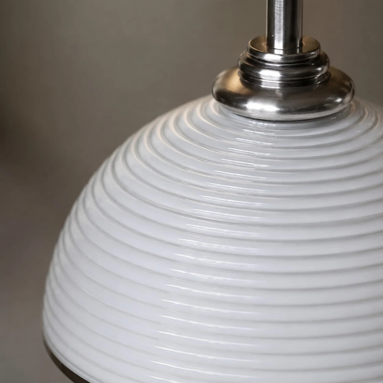 Metal socket and upper hardware on the white ribbed pendant shade