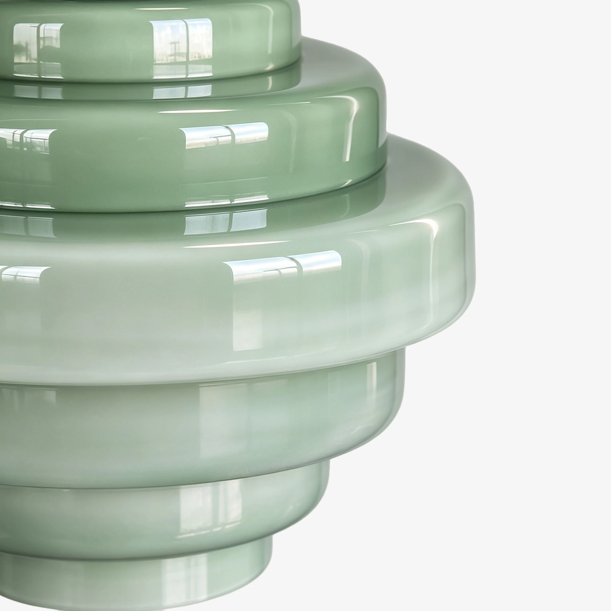 Primer plano de una pantalla colgante de cristal con degradado verde brillante.