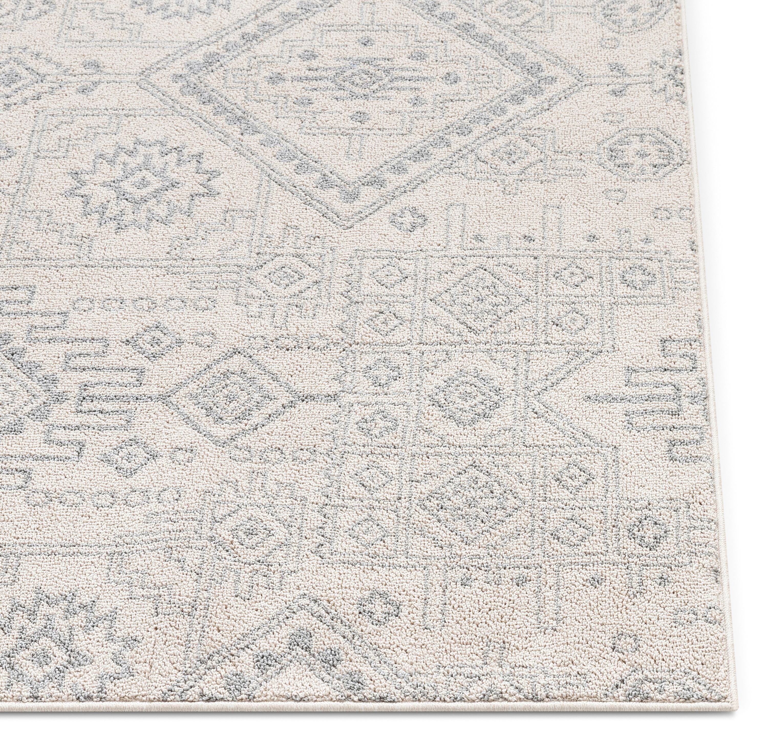 Molly Cremefarbener moderner Ikat-Stammesteppich
