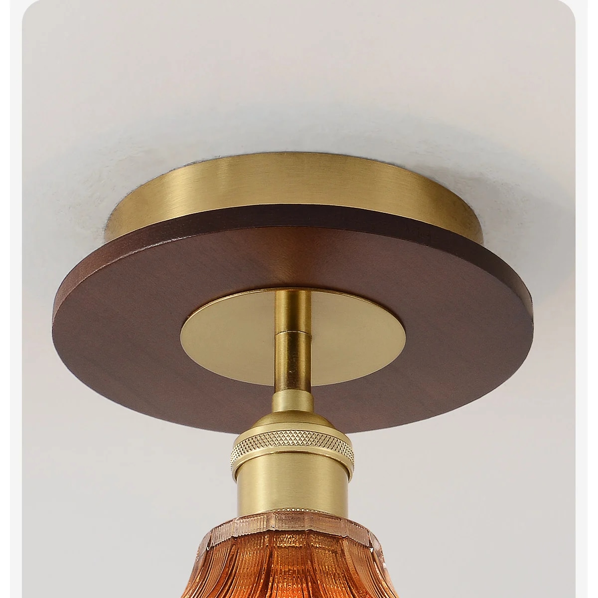 Brown ceiling plate and warm metal fitting detail