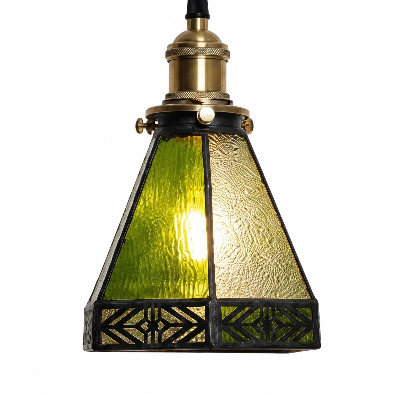 Green and amber textured glass pendant shade lit with warm light