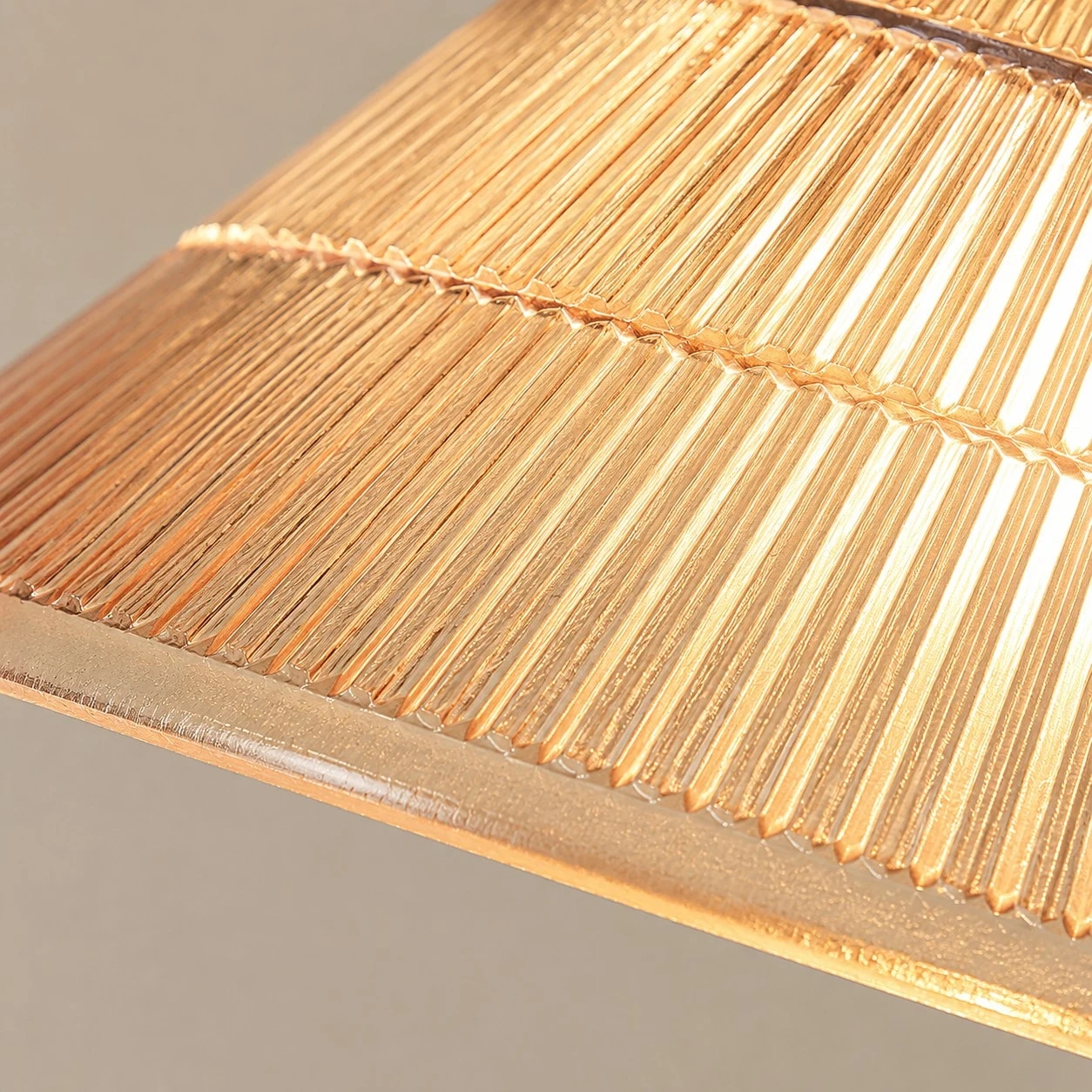 Ribbed shade, warm metal, and wood-tone contrast