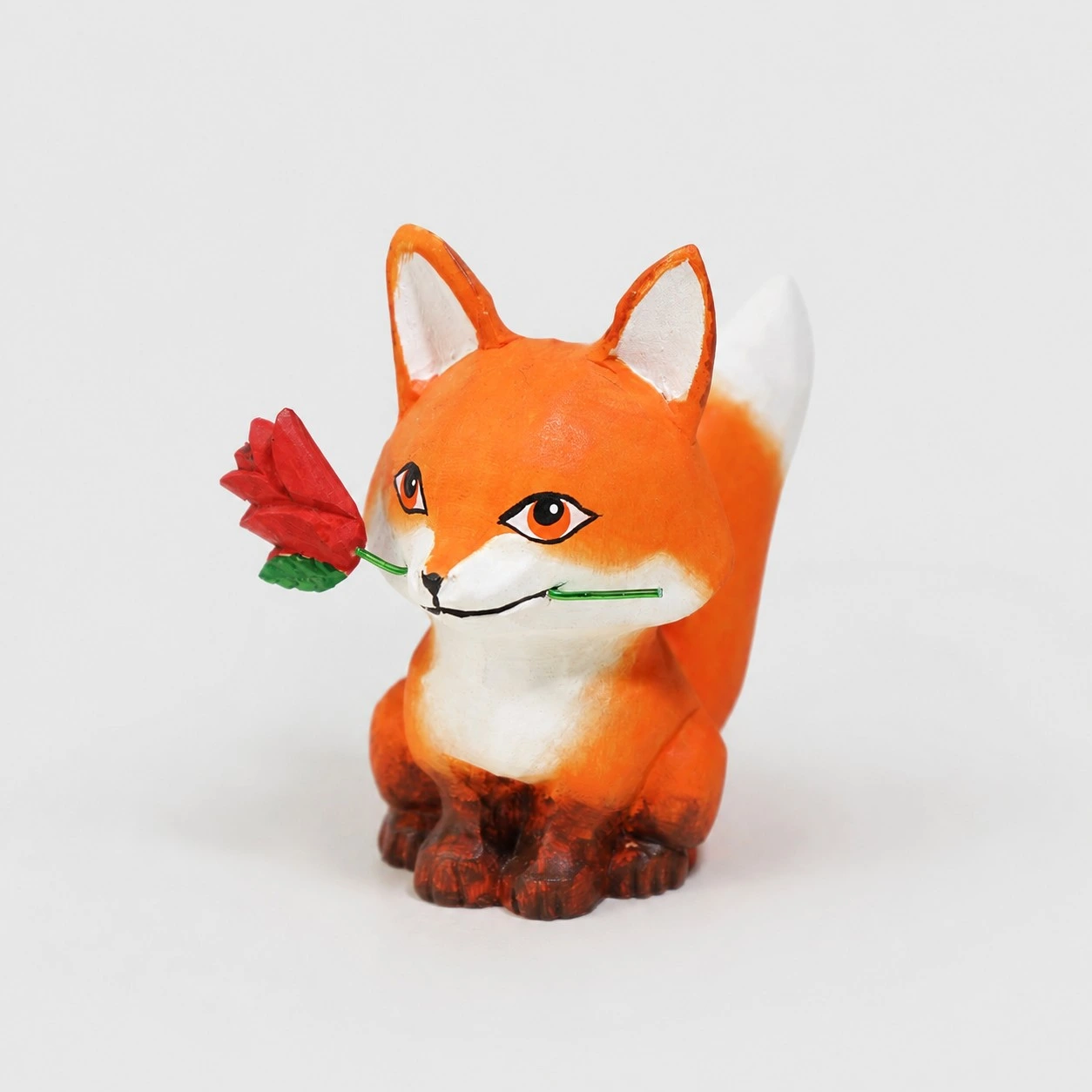 Renard tenant une rose