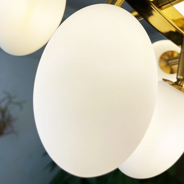 Luminate Living - Zygote High-quality white glass cluster chandelier. Organic-inspired design paired with luxury materials. Perfect for dining rooms, living areas, entrance halls, hotel areas, restaurants, etc. White glass clusters with base frame in French gold color or Raw copper.
