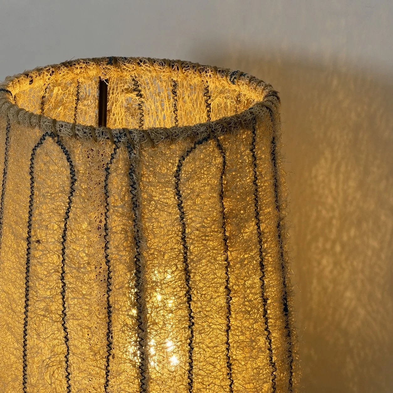 Close view of glowing natural woven fiber shade texture