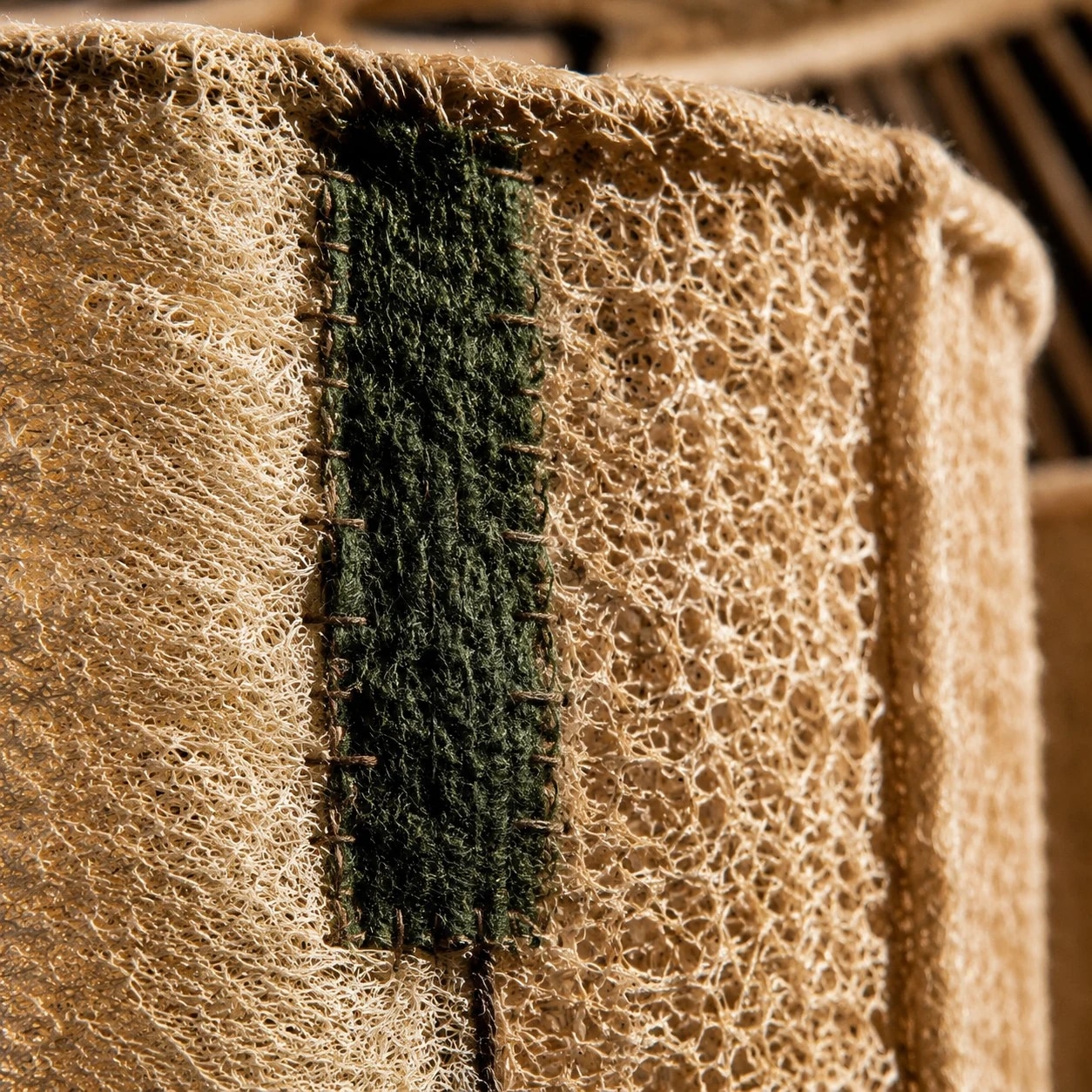 Close view of green seam and woven edge detail