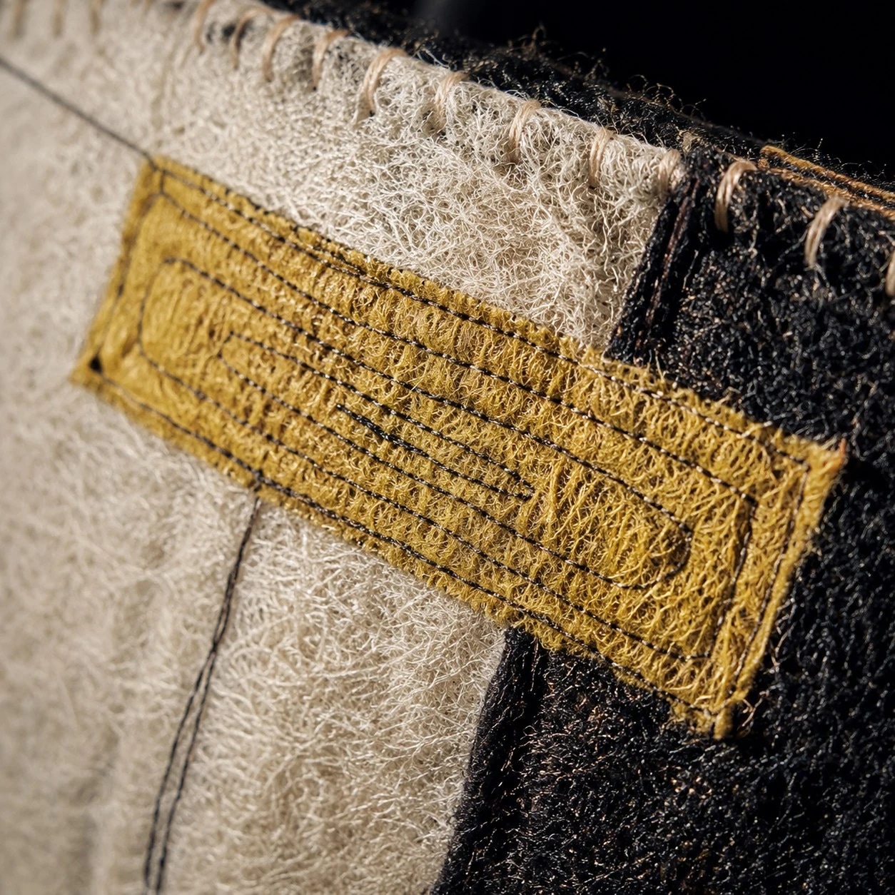 Close view of stitched tab and woven panels