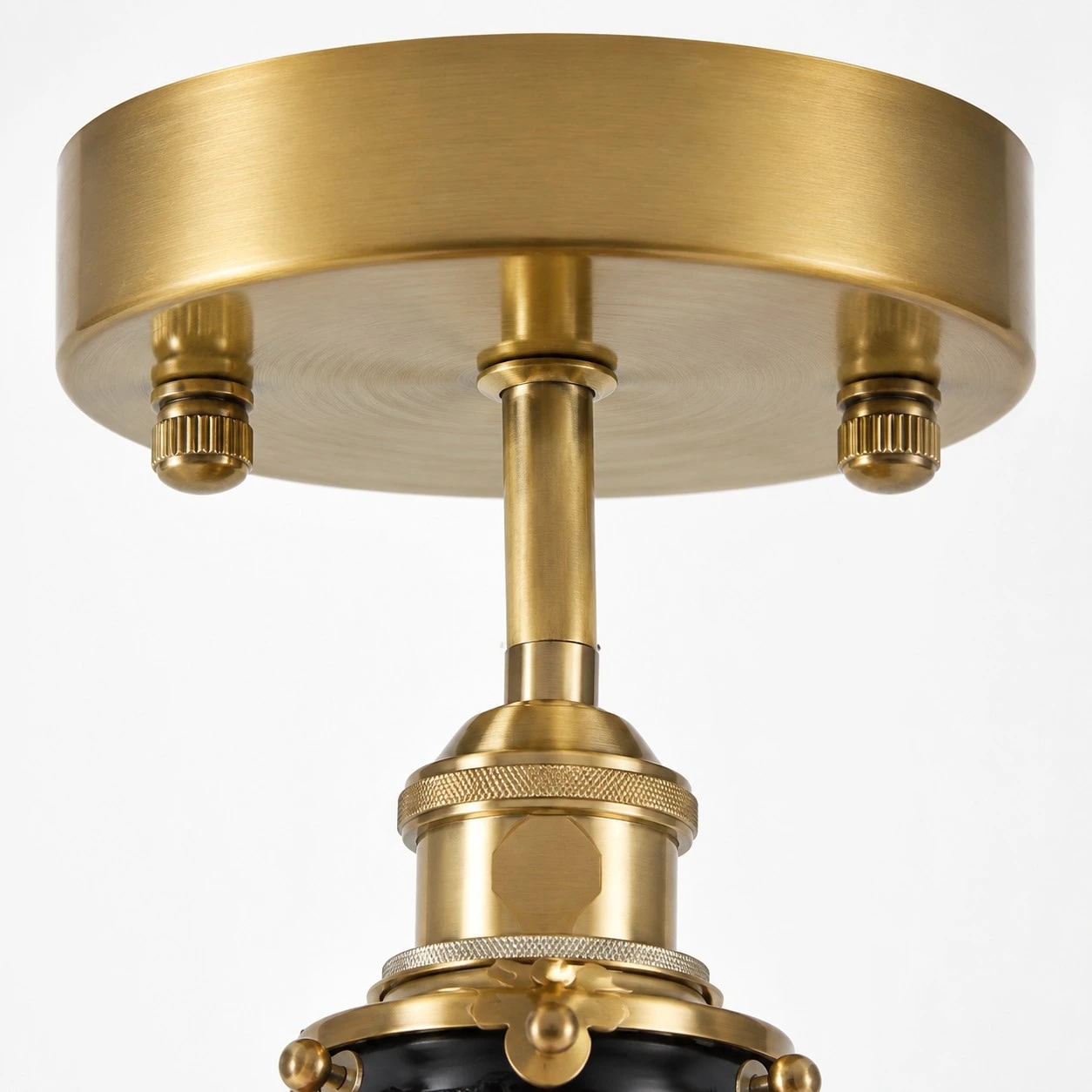 Brass-tone ceiling canopy and fixture stem detail
