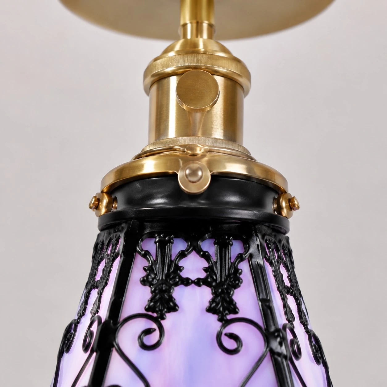 Upper stained-glass shade hardware and black decorative frame detail