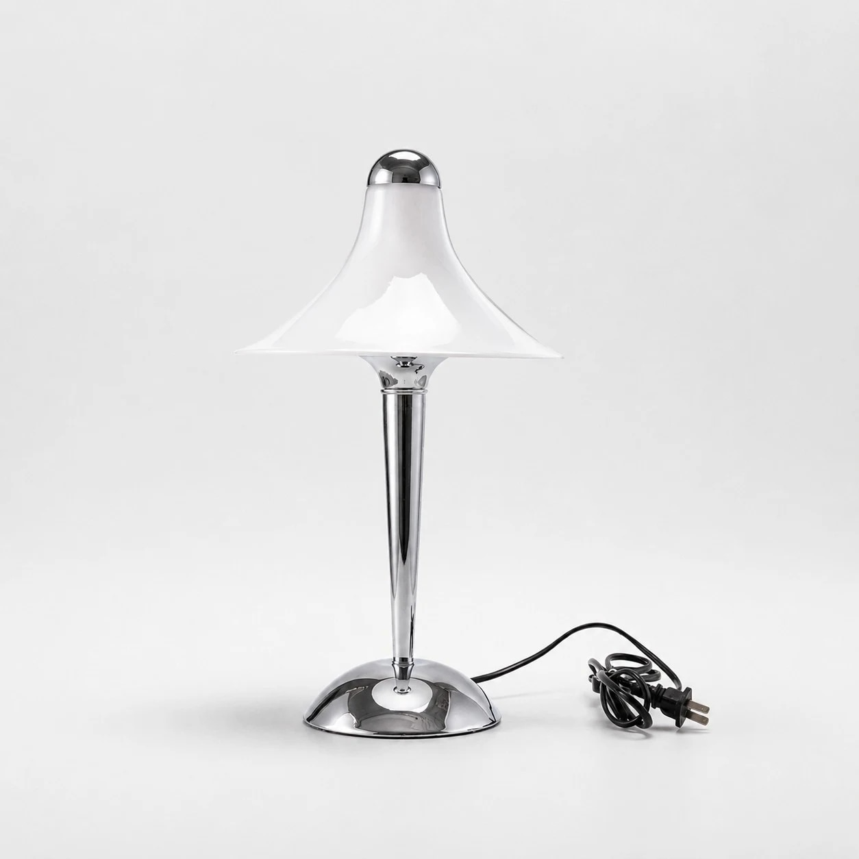 Close view of the flared white shade and chrome stem