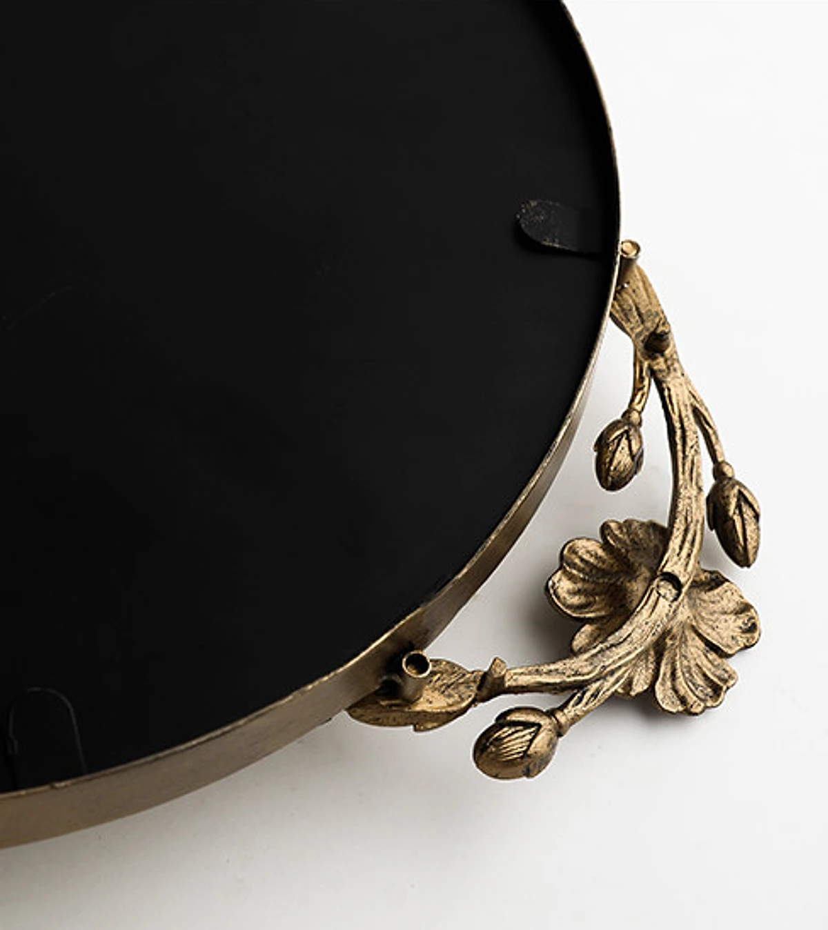 Black lacquered underside and antique-gold floral handle detail
