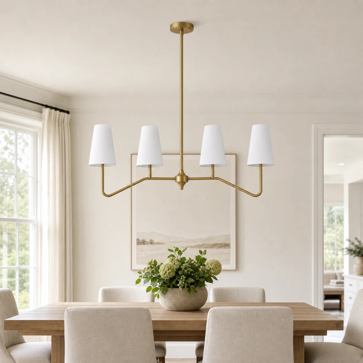 Strellux brass linear chandelier above a dining table