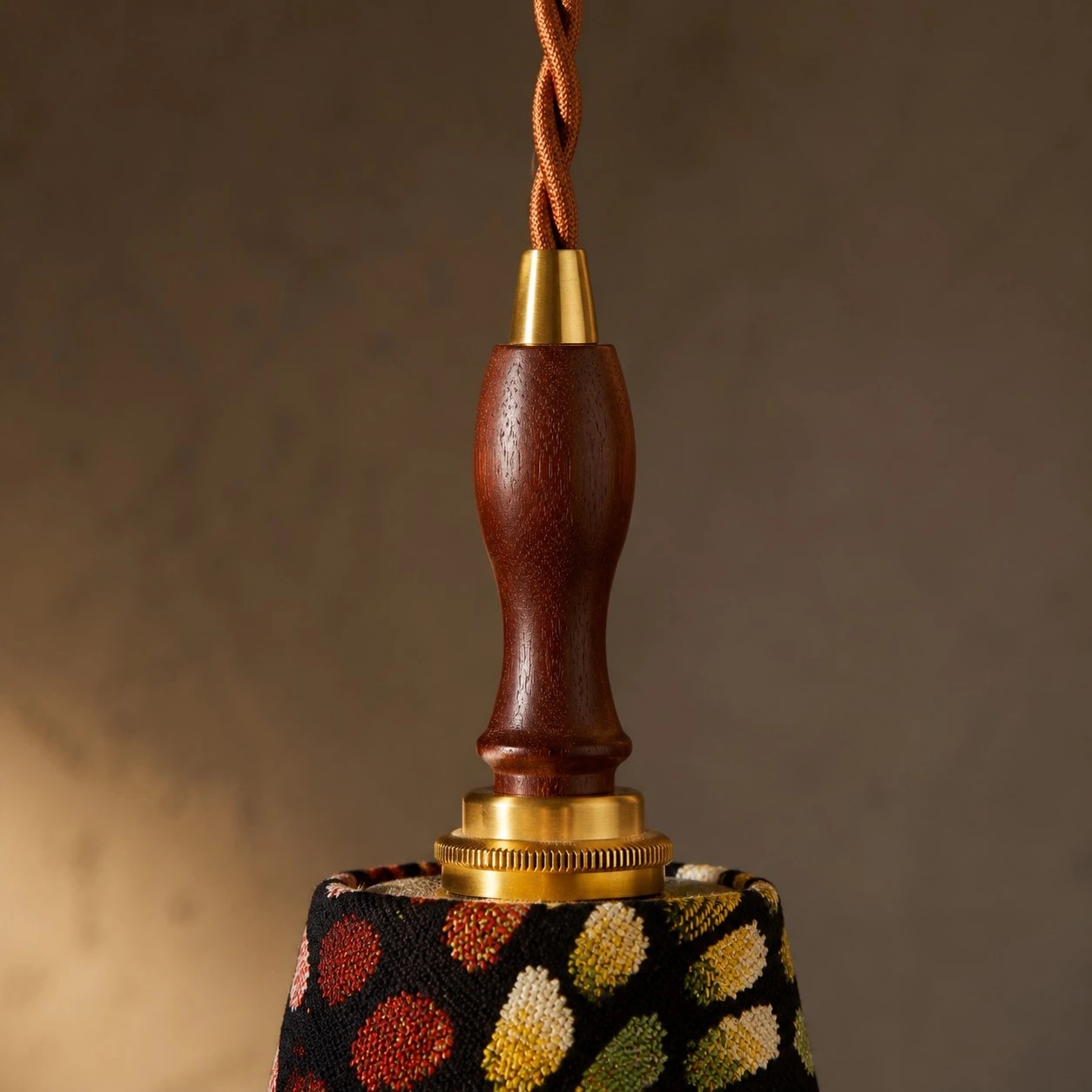Close view of the wood handle and braided cord