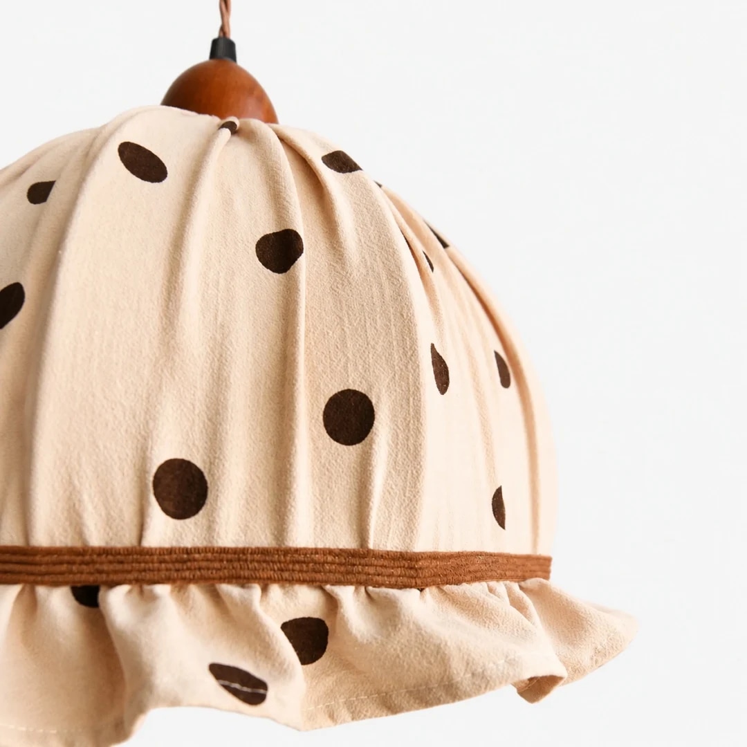 Cream polka dot fabric pendant lamp in a cozy interior setting