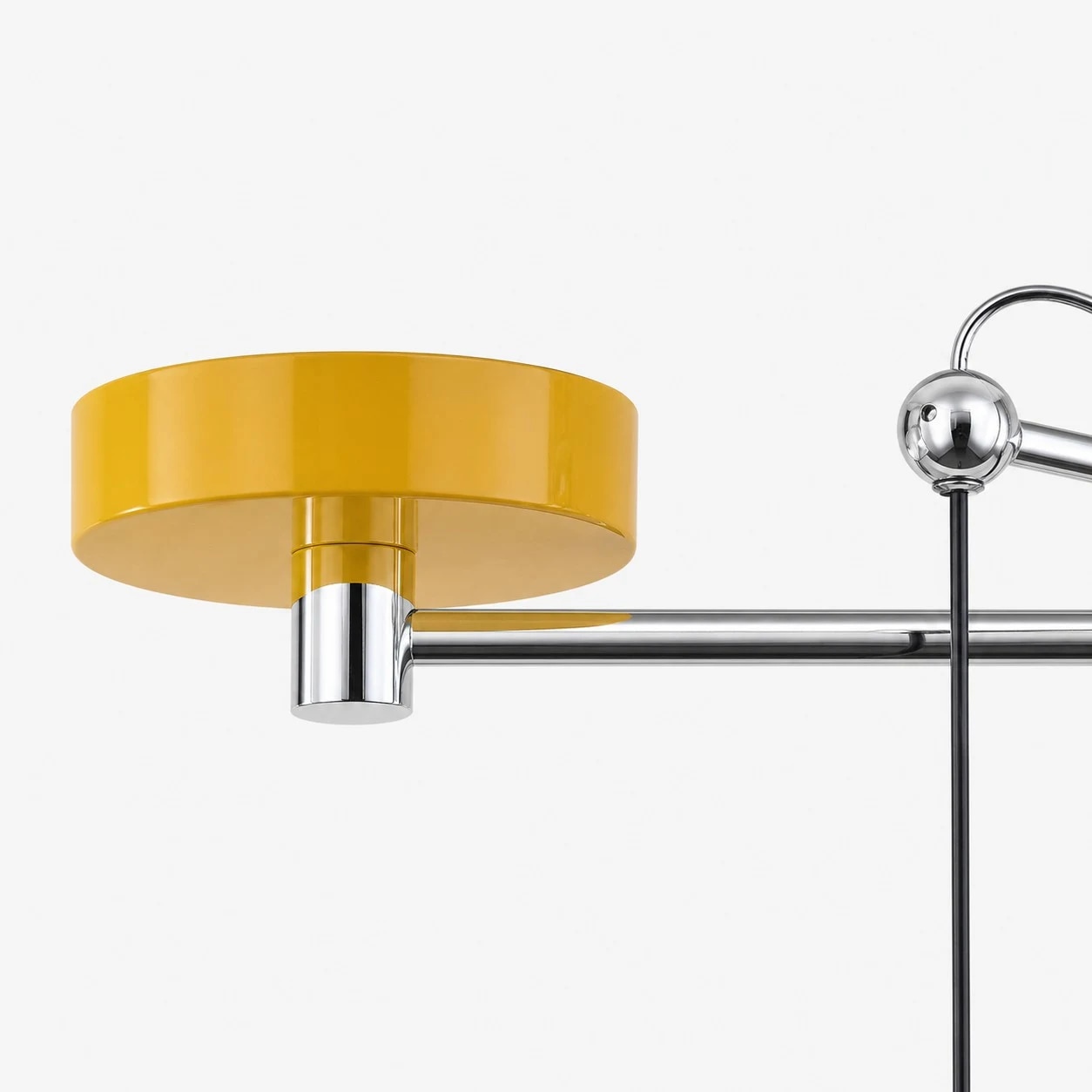 Yellow ceiling canopy and chrome arm hardware detail