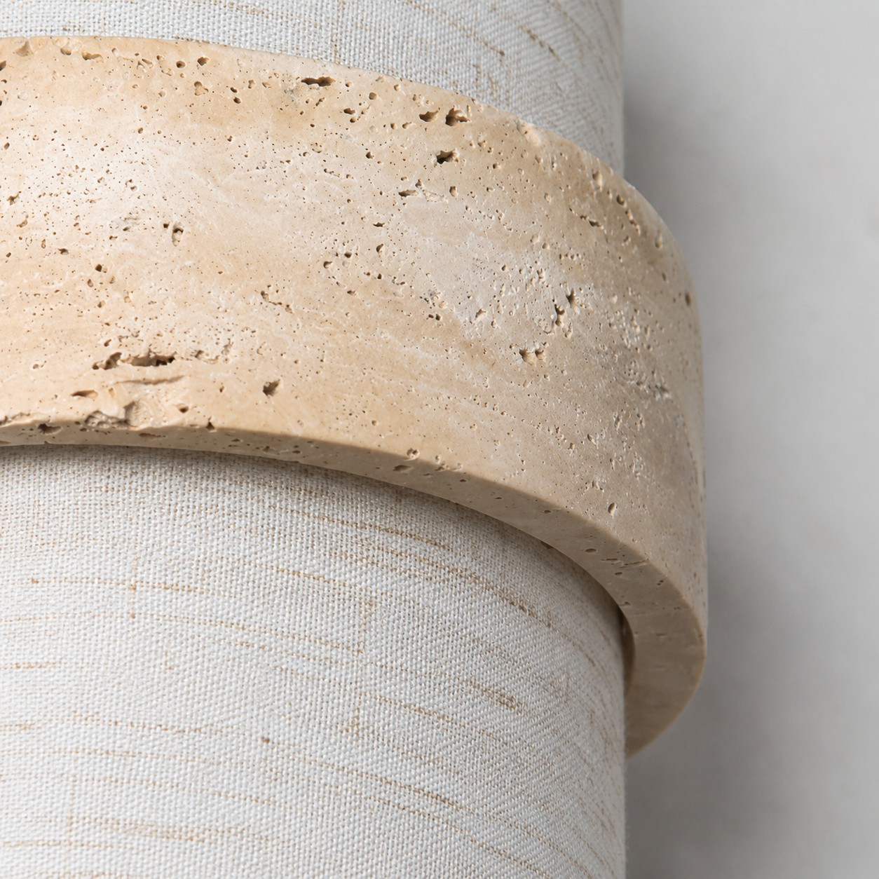 Close-up of yellow travertine and fabric shade