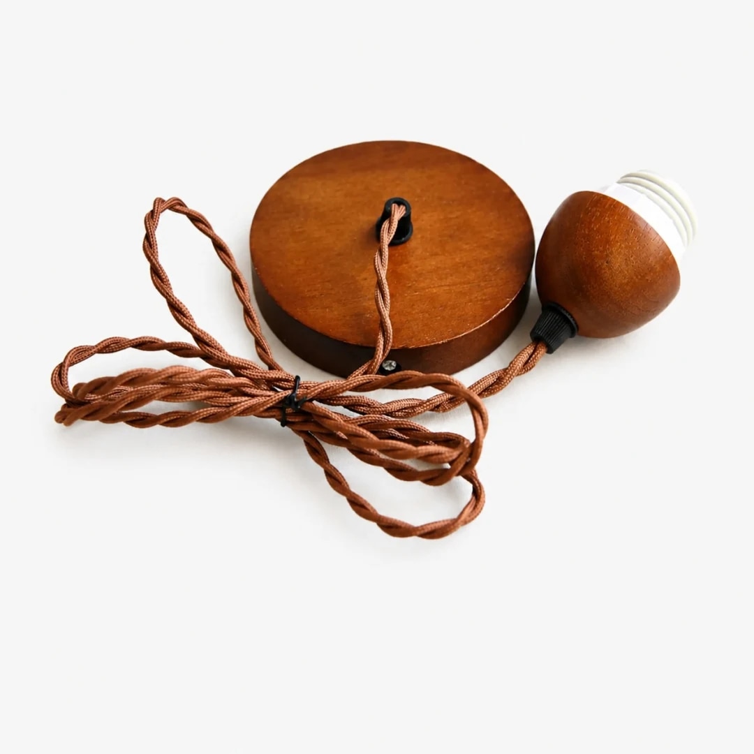 Wood canopy and braided cord detail for the pendant lamp