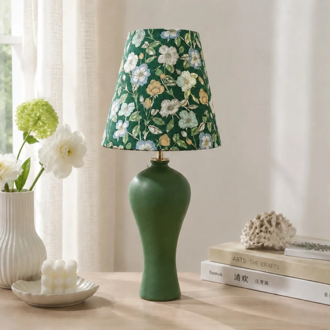Green floral ceramic table lamp styled near a bright window