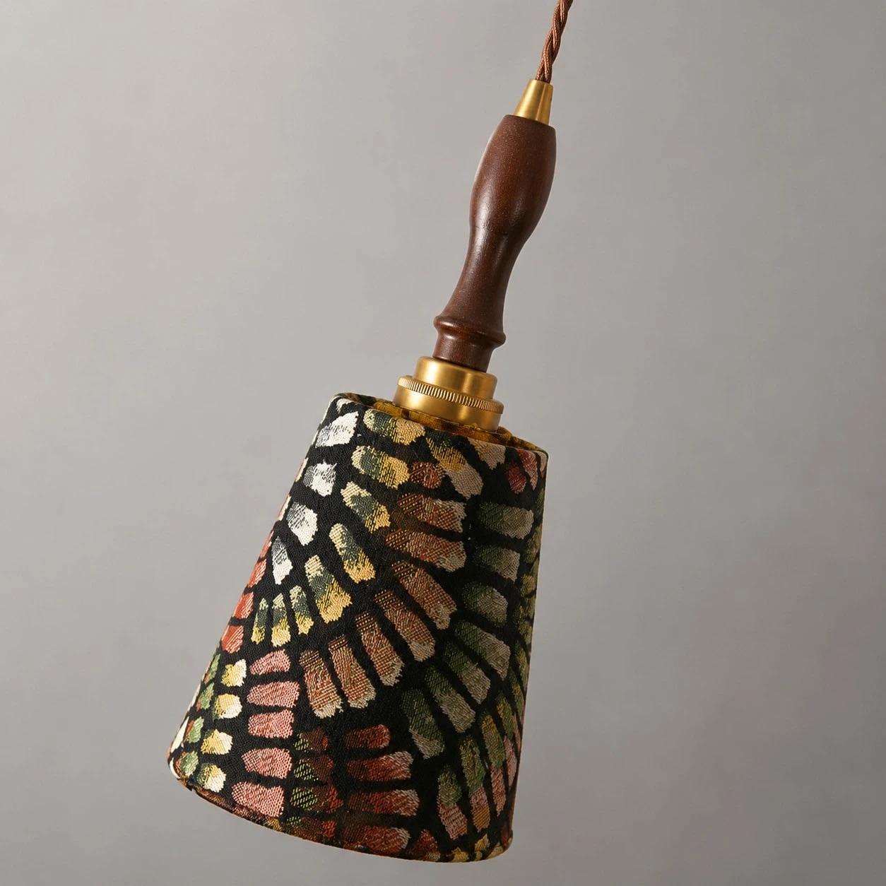 Close view of the patterned cloth shade and wood handle