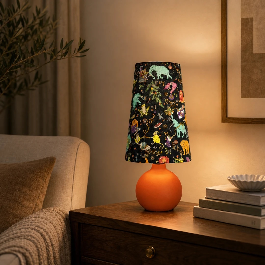 Colorful fabric table lamp styled on a bedside table in a warm room scene